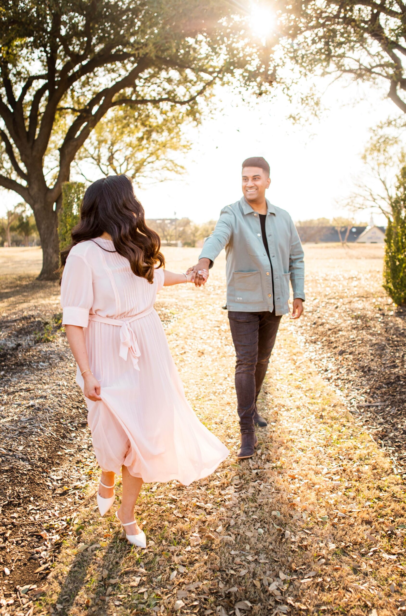 Couple running in engagement photo session in Dallas