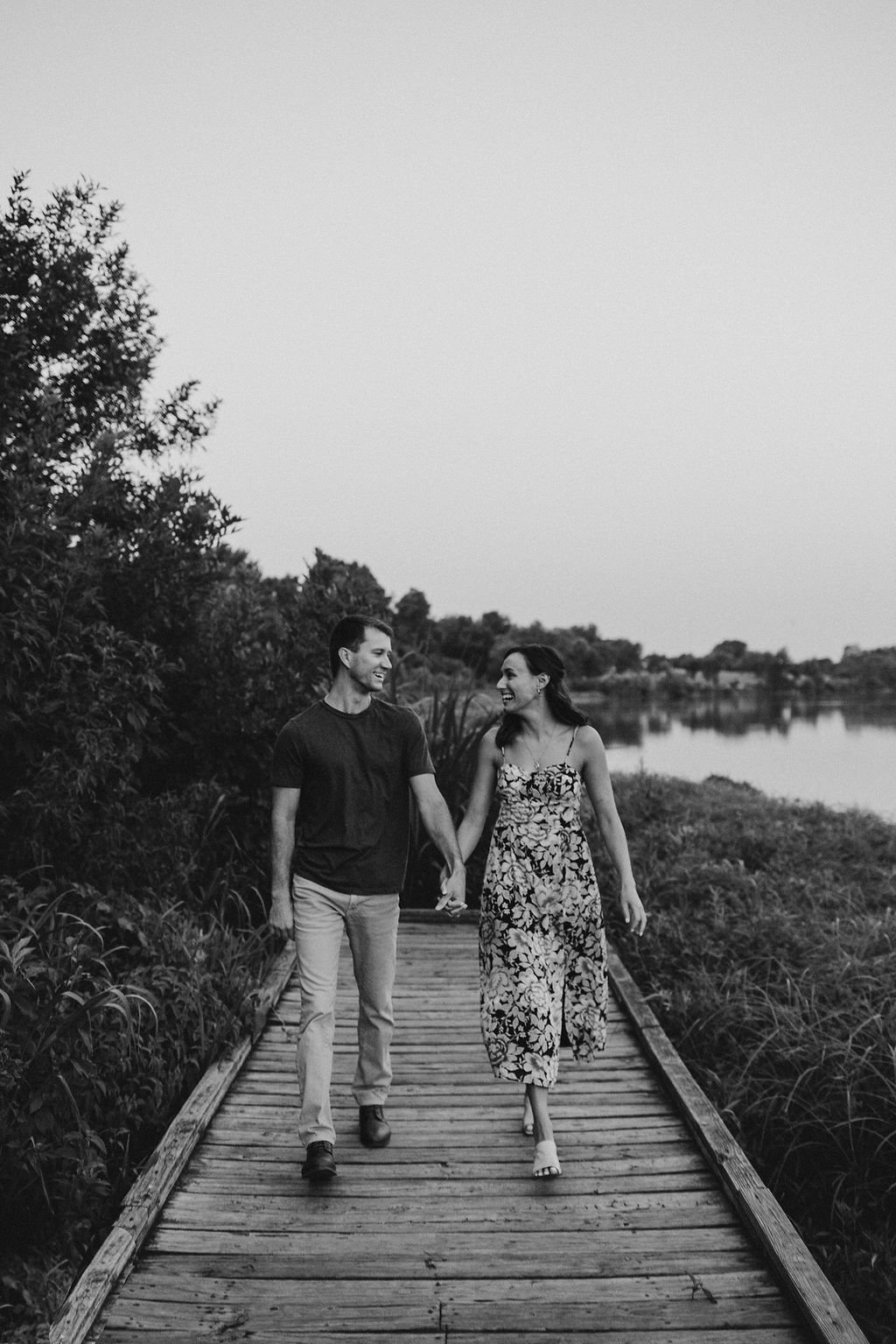 Couple walking for engagement photos at white rock lake 
