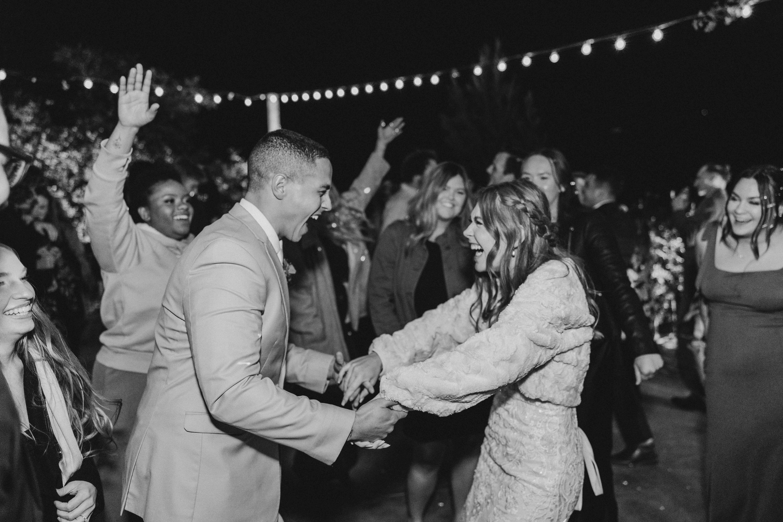 fun outdoor wedding reception photo of dancing in black and white at Secluded Garden Estate
