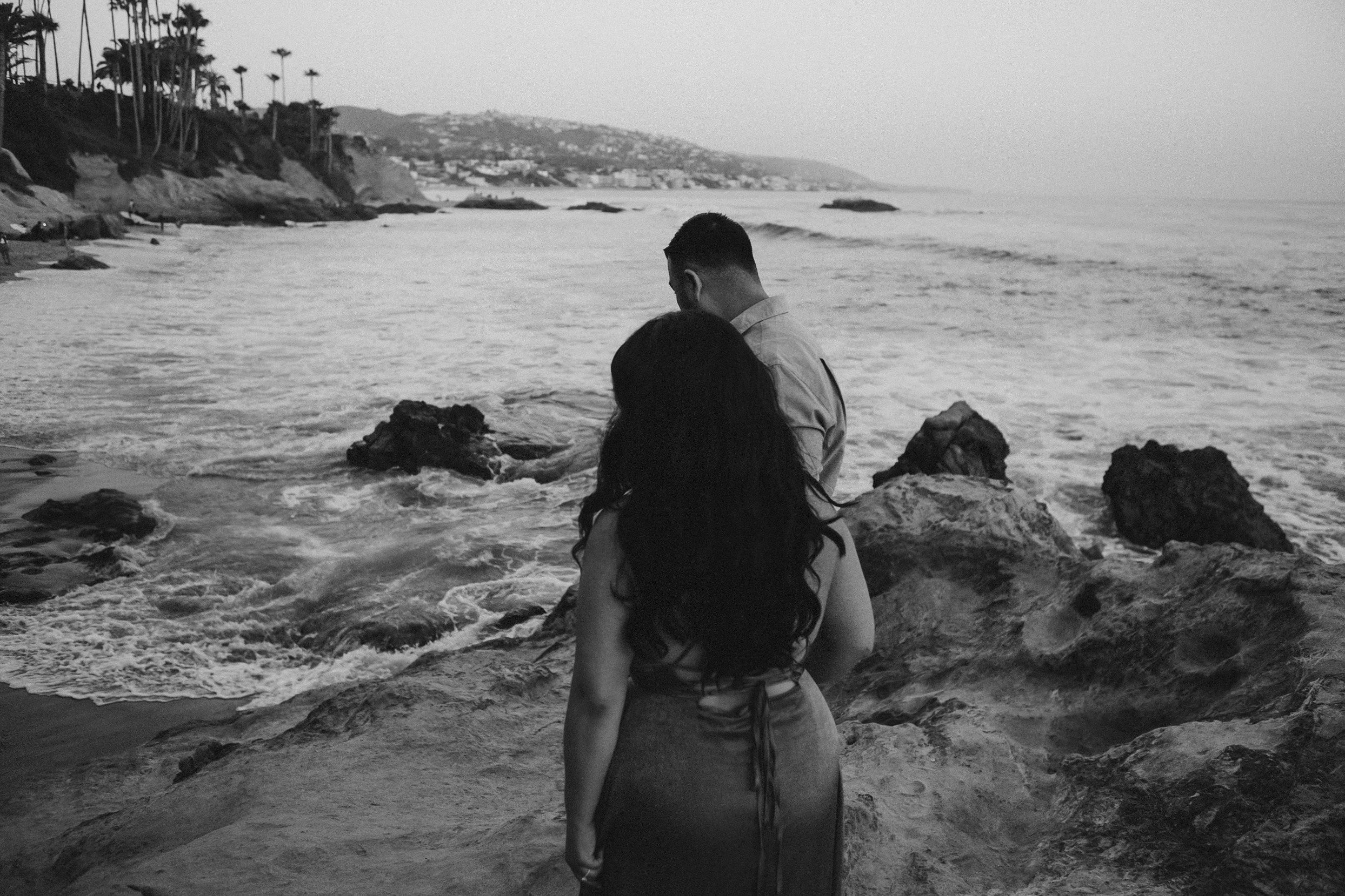 black and white engagement photo at Laguna Beach by the ocean